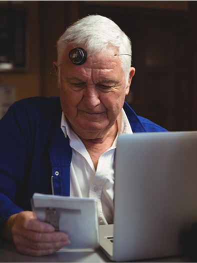 Retiree reviewing financial documents on a laptop